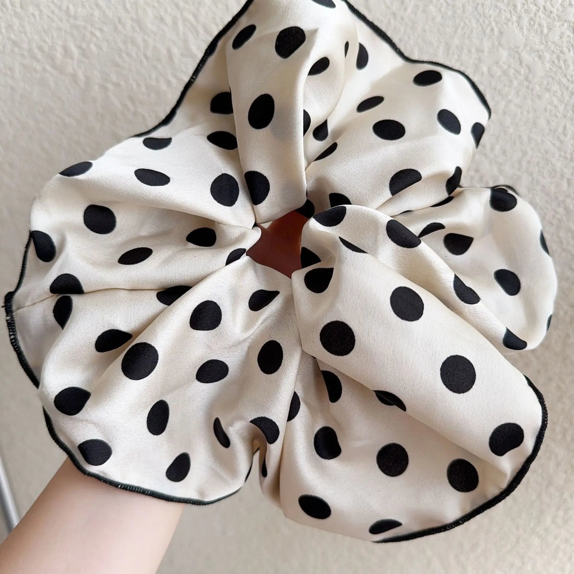 White cotton polka-dot scrunchie with black dots, gathered circular bow