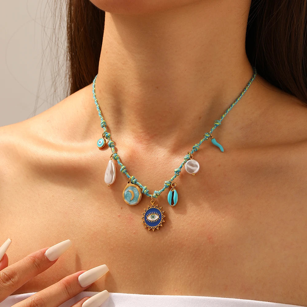 Turquoise beaded pendant necklace with moon, eye, pearl drops and heart charms