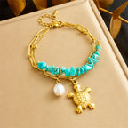 Turquoise beaded double-layer necklace with gold pearl and turtle charm, on display box