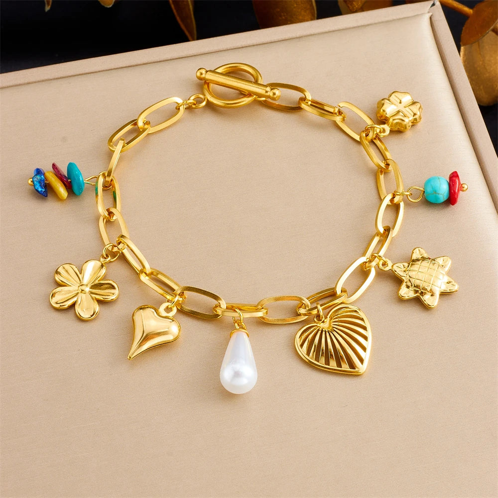 Gold-tone charm bracelet with flower, heart, shell, pearl and turquoise bead charms