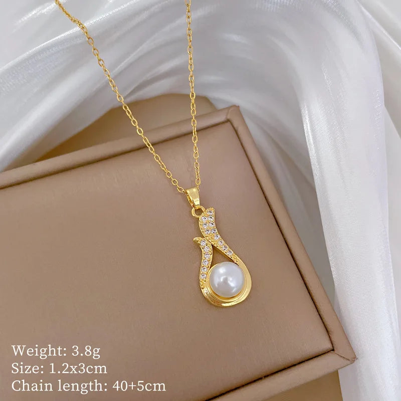 Gold-tone pearl drop pendant necklace with crystal halo detail