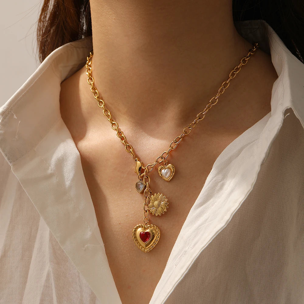 Gold tone heart and flower pendant necklace with red zircon heart and white pearl charms