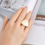 Gold-tone teardrop tiger stripe ring on fingertip