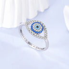 Sterling silver evil eye ring with blue eye centerpiece and crystal-detailed band
