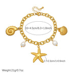 Gold-plated charm necklace with starfish pendant, shell charm, and white pearl bead accents