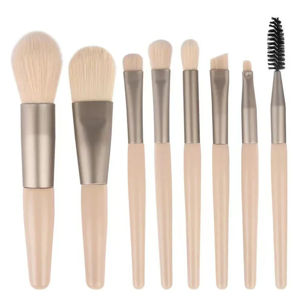 Makeup brush set with beige handles and light bristles; includes black spoolie