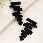 Geometric stud earrings in black with angular zigzag blocks and layered edges