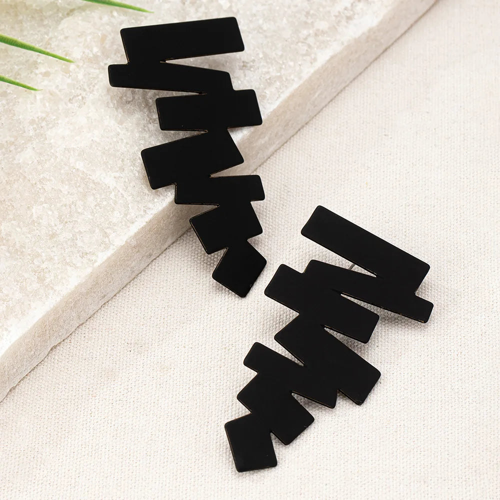 Geometric stud earrings in black with angular zigzag blocks and layered edges