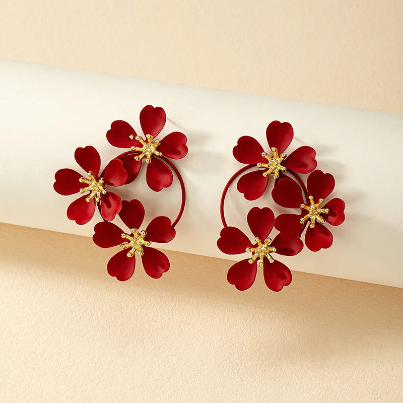 Flower dangle earrings with red five-petal flowers and gold-tone hoop loops