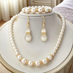 Pearl bridal jewelry set with pearl necklace, matching bracelet, and drop earrings