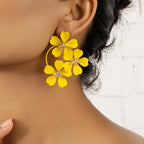 Flower dangle earrings with yellow five-petal flowers and gold-tone hoop loops
