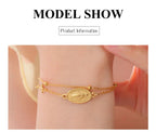 Gold-tone cross pendant bracelet with oval Virgin Mary medallion centerpiece on chain