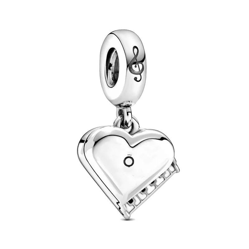 Sterling silver charm bead with heart-shaped cutout and small circle detail