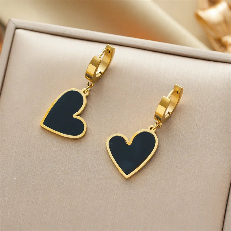 Gold-plated hoop earrings set with dark heart shell charms
