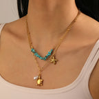 Turquoise beaded double-layer necklace with gold turtle and starfish charms, worn on neck