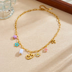 Gold enamel pendant necklace with heart center charm and colorful flower and bow pendants