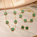 Gold-tone clover jewelry set with green enamel necklace, bracelet, and stud earrings