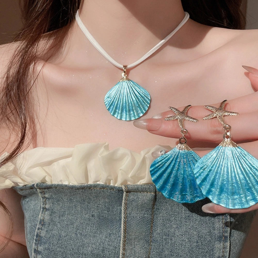 Blue shell pendant necklace with gold starfish dangle earrings, scallop shell drops