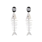 Silver-tone fishbone dangle earrings with black-and-white striped ovals and fish charms