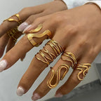 Geometric open stacking ring on fingers, gold-tone ribbed open wave bands