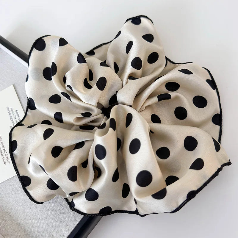 Polka dot cream scrunchie with a full bow shape and elastic gathered center
