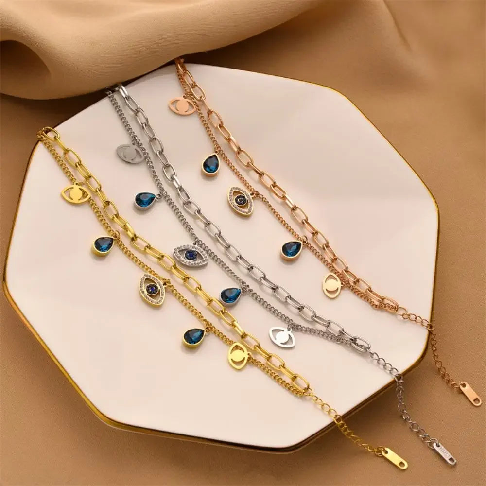 Evil-eye double bangle set in gold and silver with blue charm pendants