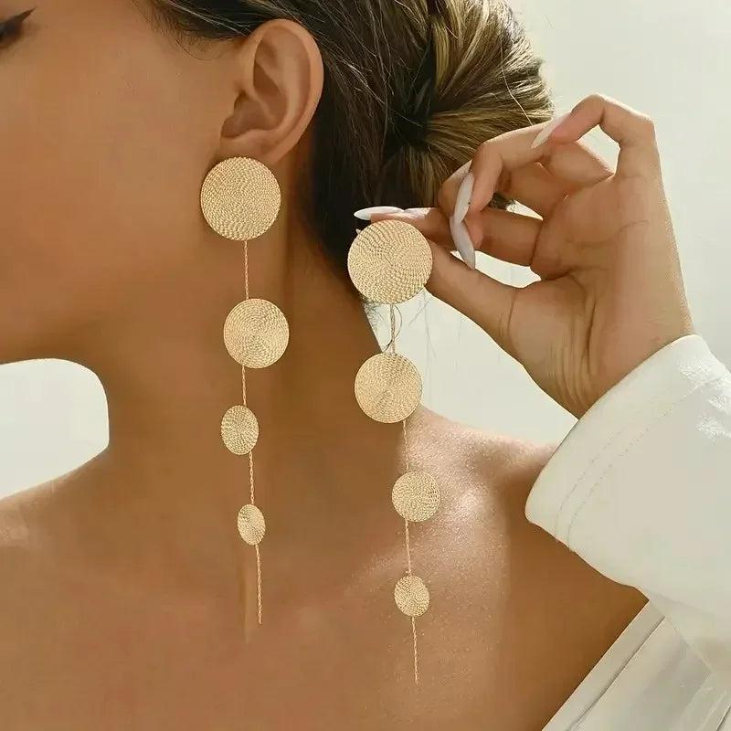 Bohemian tassel earrings with round woven discs and thin dangling chains, gold tone