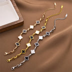 Four-leaf clover charm bracelet with gold-tone chain and white enamel clover charms