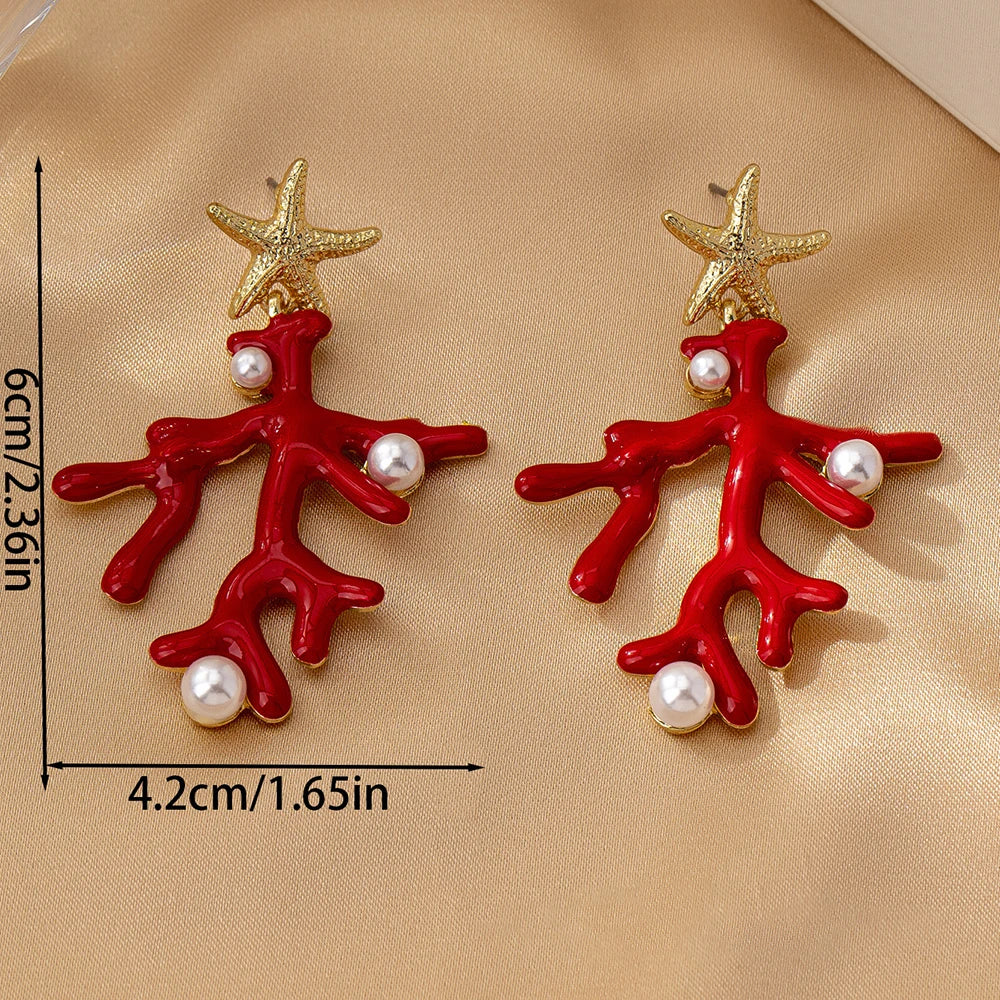 Coral starfish earrings with red enamel, gold-tone sea stars, and pearl-like bead drops