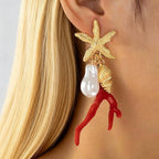Star-and-figure resin earrings with red coral drops, white pearls, gold-tone finish