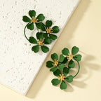Flower dangle earrings with dark green five-petal flowers and gold-tone hoop loops