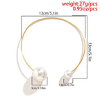Gold-tone pearl collar necklace with round white beads on a thin loop chain