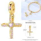 Gold-tone charm with cross shape and pink and clear gemstone accents