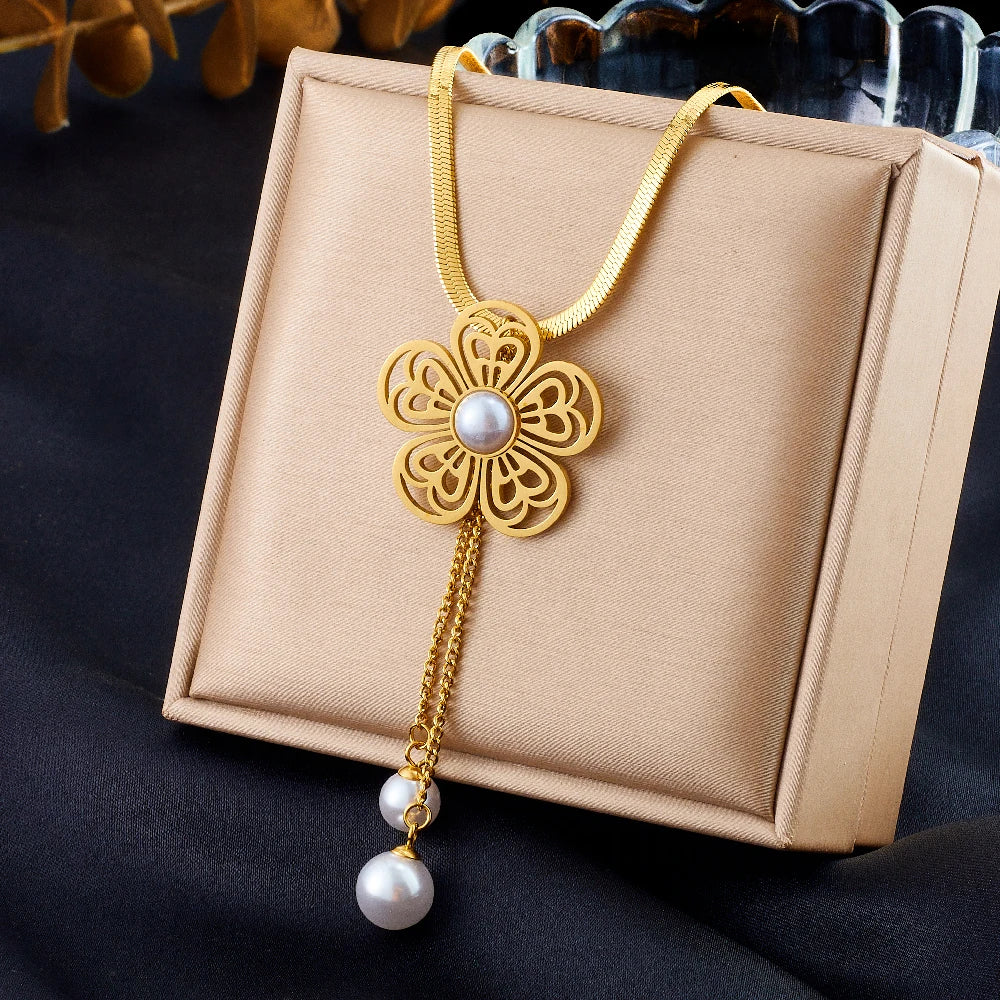 Gold-tone flower necklace with white pearl drop and hanging pearl detail