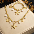 Gold-tone charm necklace with starfish pendant, seashell charms, and white pearl beads