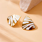 Gold-tone teardrop earrings with white tiger stripe stripes, glossy pair