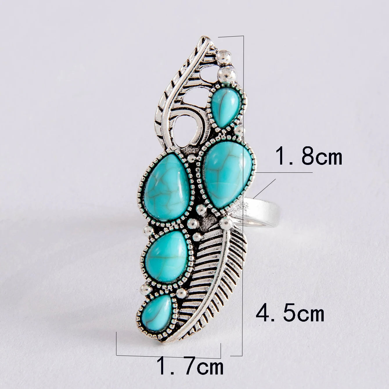 Turquoise boho cabochon ring with ornate metalwork, scalloped edges, and feather motif