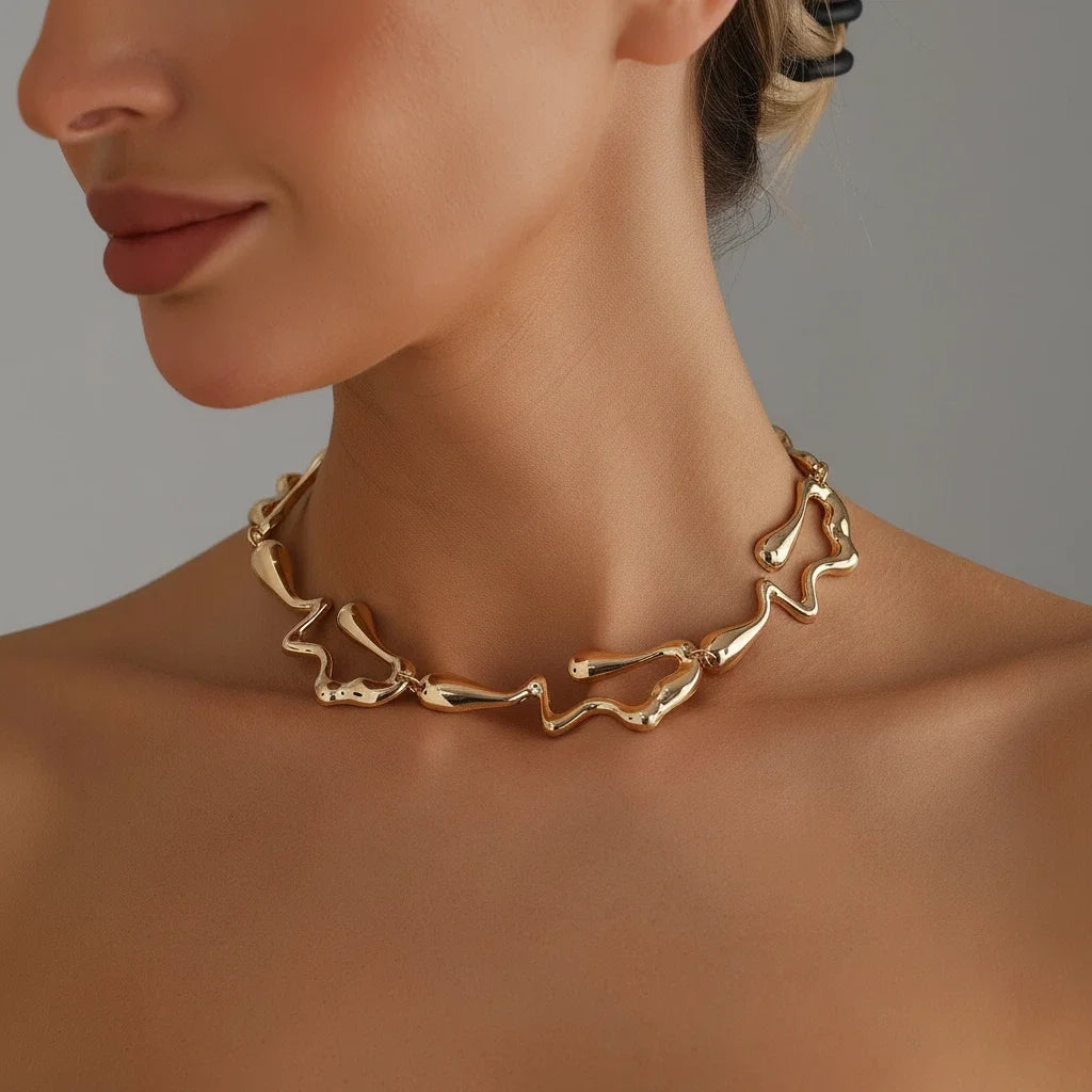Gold-tone lava drip choker necklace worn with matching drop earrings