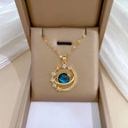 Gold-tone planet pendant necklace with blue gemstone center, star and halo zircon stones