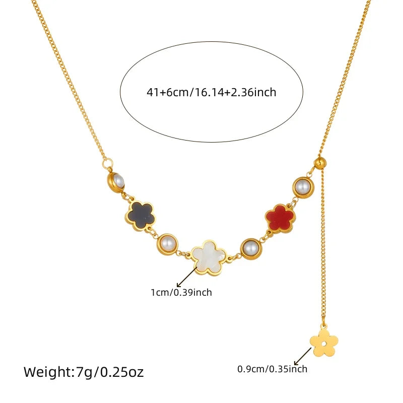 Gold-tone five-petal flower necklace with white pearl accents and charm beads