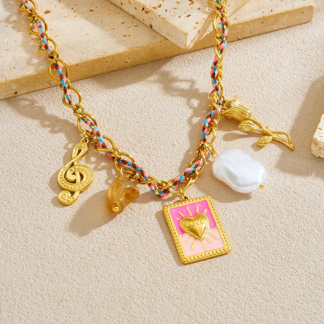 Rainbow-link charm necklace with pink heart pendant, white baroque pearl, and gold accents