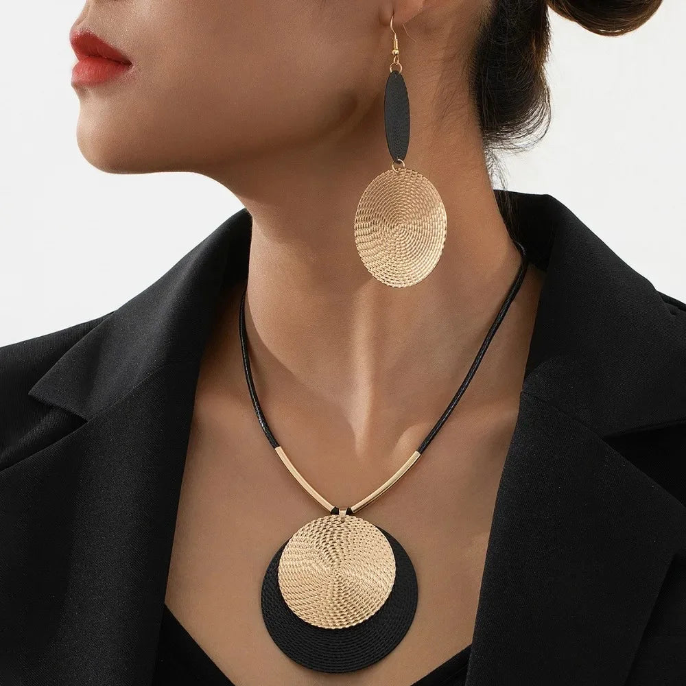 Round statement earrings set with layered gold and black round disc dangles, zinc alloy
