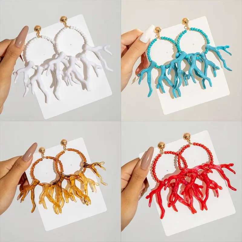 Acrylic drop earrings in white, turquoise, brown, and red with bead hoops and fringe