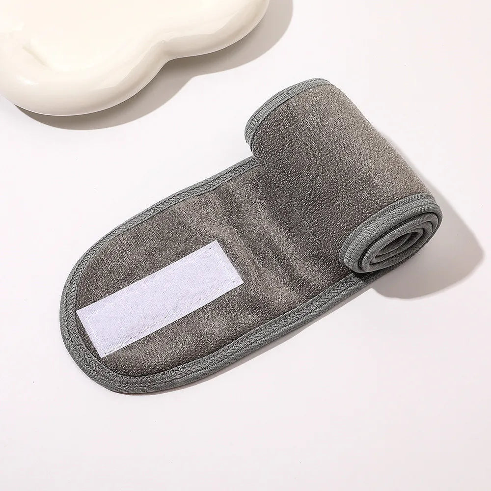 Yoga face wash headband in dark gray with white label patch and rolled edge