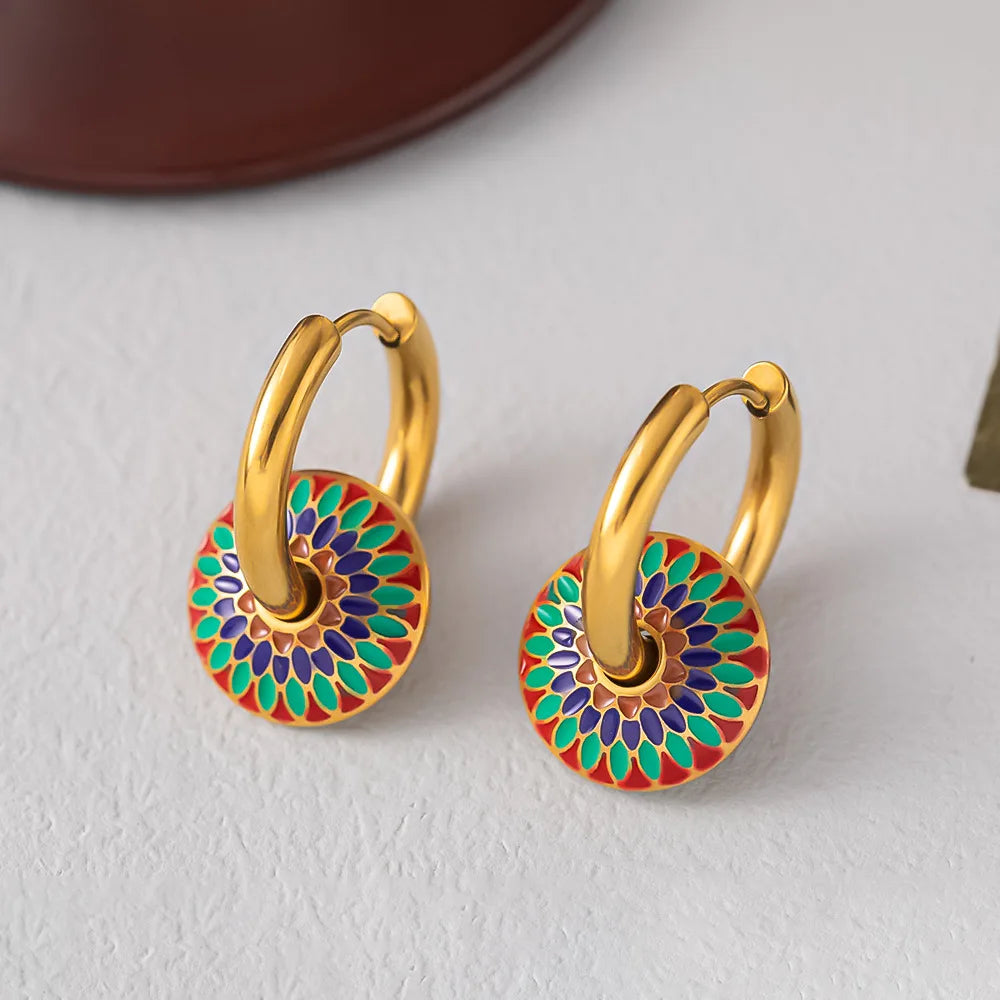 Pair of gold-tone hoop earrings with colorful painted flower disc pendants