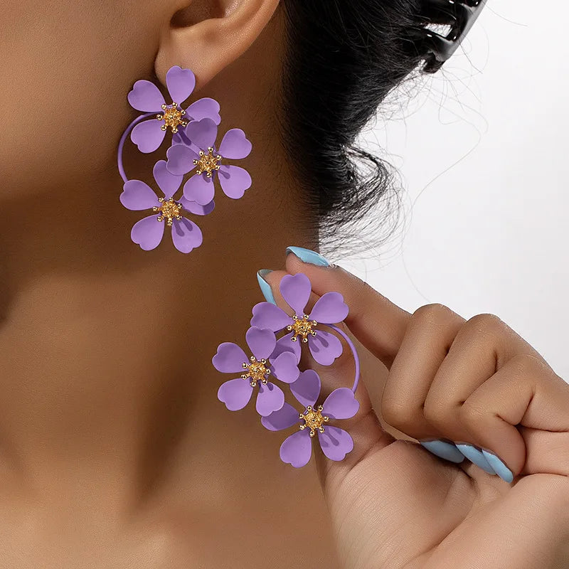 Flower dangle earrings with light purple five-petal flowers and gold-tone hoop loops