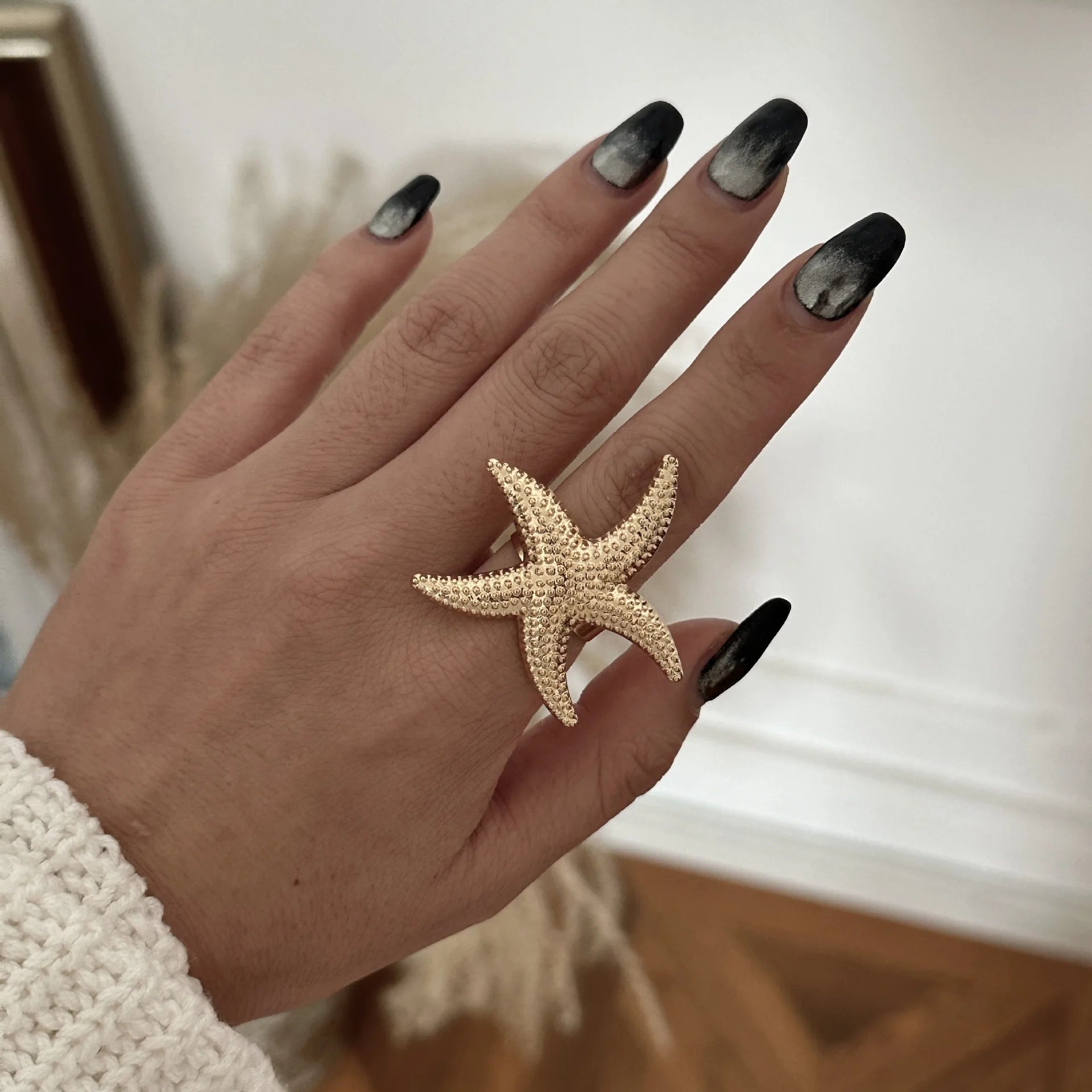 Gold starfish pearl ring with textured star design and small beaded detail