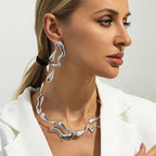 Silver choker necklace and drop earrings with wavy lava-inspired shapes