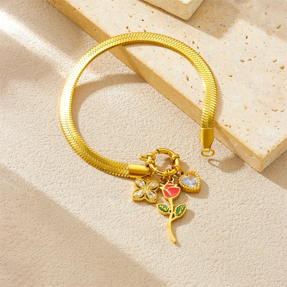 Gold-tone snake chain necklace with rose flower pendant and red enamel accents