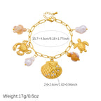 Gold-tone ocean charm necklace with pearls and crab, turtle, scallop-shell pendants